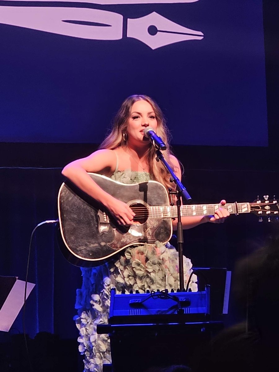 Lauren Mascitti sings and plays acoustic guitar