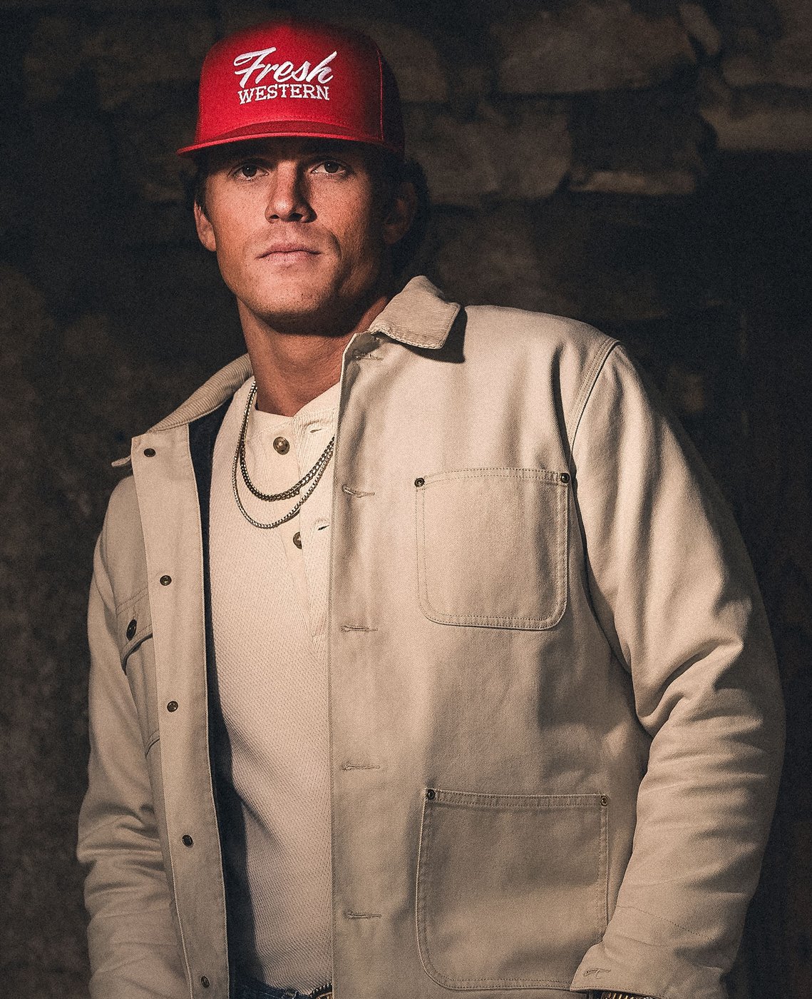 Parker McCollum in a red Fresh Western cap and canvas jacket